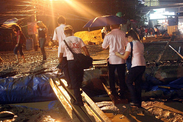 MUDDY. Students and other passersby avoid the mud in crossing the road near the Mindanao University of Science and Technology (Must) in Lapasan following uesday’s downpour. (NITZ ARANCON)