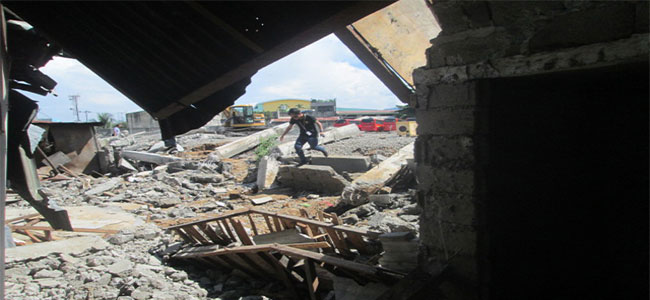 10-foot wall collapses, crushes a dozen houses