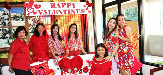 Nearby, city council employees in red strike a pose after giving their office a Valentine’s Day makeover yesterday. (PHOTO BY NITZ ARANCON)