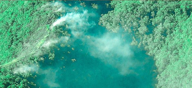 FOREST FIRES. “Contained fire means that there are no more flames, but there is still smoke coming from the burnt areas. The fires are not yet effectively put out. Fires may still recur, depending on the general wind direction, prevailing humidity and temperature, as what happened in some areas a few days back,” Office of Civil Defense 10 Regional Director Ana Cañeda said. This aerial photo was taken near Cagayan de Oro City’s watershed area. (Photo by Ana Cañeda for OCD 10)