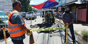 Cagayan de Oro Water District (COWD) workers setting up safety signs for a water pipe repair on Vamenta Boulevard, Barangay Carmen.
