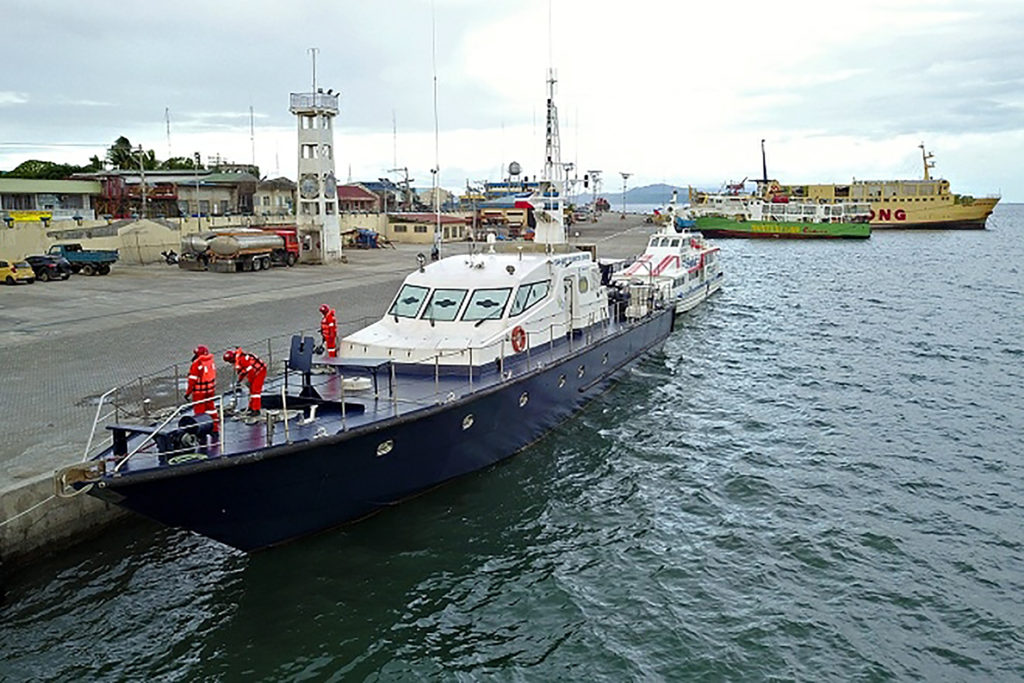 Crew members prepare a gunboat for rough waters and bad weather along with other vessels docked at the Surigao port before a storm struck this week. 