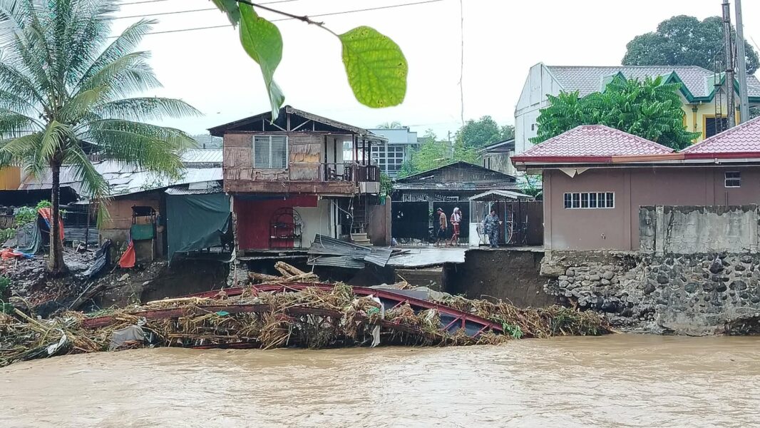 Residents of Barangay Pala-o, Iligan City, wade through knee-deep floodwaters caused by Tropical Typhoon Basyang, forcing families to evacuate overnight. "We just rebuilt our lives after the fire, and niw this happen again," said resident Gee Collantes, as flooding and damaged infrastructure cut off access to essential services. (Photo by Bonita L. Ermac)