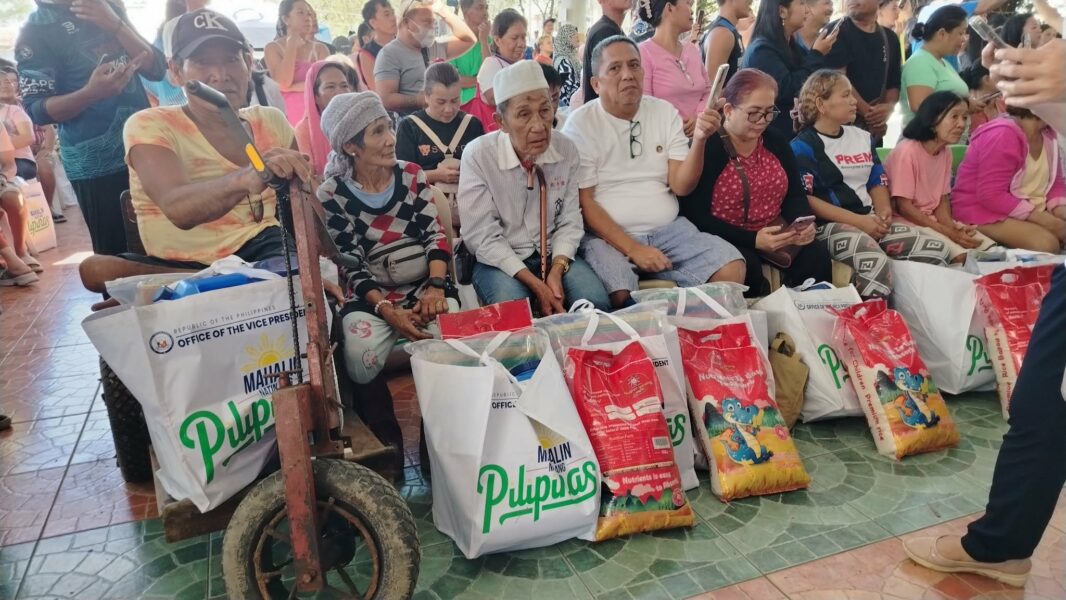 Vice President Sara Duterte distributing relief packs to Iligan City residents displaced by Tropical Storm Basyang. VP Sara visits flood victims during recovery efforts in Iligan.