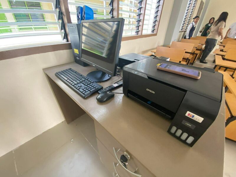 Modern tech-enabled classroom at Bulua National High School featuring an LED TV, PC station, and ceiling projector for interactive learning.