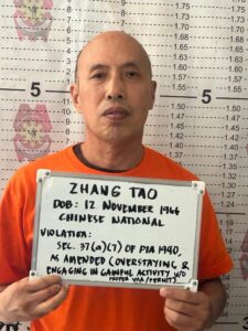 Bureau of Immigration and Philippine Army personnel arresting two Chinese nationals for illegal gold mining and immigration violations in Sibutad, Zamboanga del Norte.