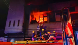 Firefighters from BFP Iligan battling a large fire at the CPK Mercantile building in Barangay Poblacion.