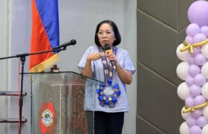 Veteran Mindanao journalist Editha Caduaya holding her international film award for the documentary "Beneath the Badge."