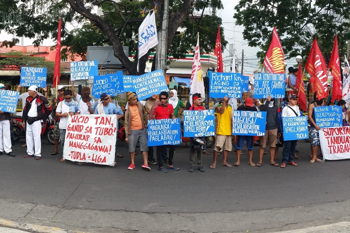 Members of the Federation of Free Workers (FFW) hold a peaceful picket line to protest the violent dispersal and termination of workers at Asia Brewery in Cagayan de Oro.