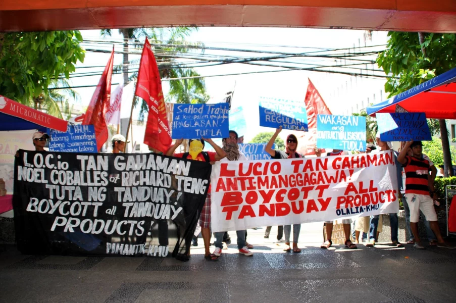 Federation of Free Workers (FFW) members protest outside the Asia Brewery, Inc. plant in Cabuyao, Laguna, following a violent dispersal of workers and the sudden termination of 139 contractual employees on the eve of Holy Week.