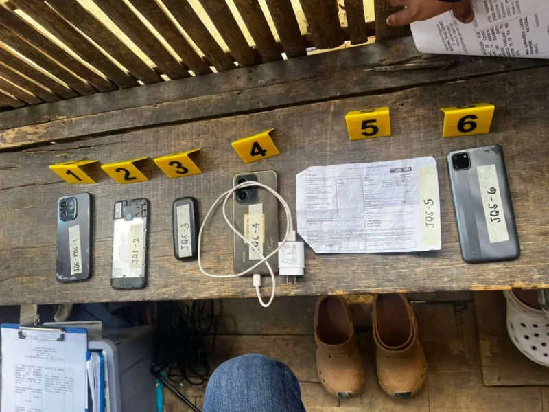 Police forensic experts examining seized laptops and digital devices for evidence of online sexual abuse and exploitation in Iligan City.