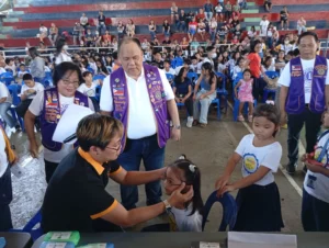 Students receiving free prescription eyeglasses at the Agusan Gymnasium in Cagayan de Oro as part of the Lions Club "Sight for Kids" program.