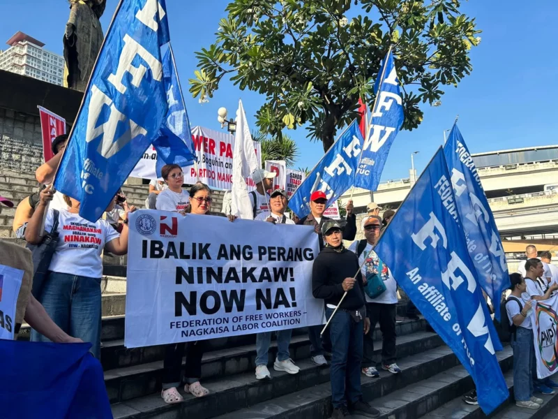 FFW and Nagkaisa Labor Coalition protesters holding banners that read "Ibalik ang perang ninakaw" during a labor rights rally in the Philippines.