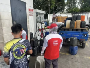 Farmers in North Cotabato fill plastic containers with diesel fuel for agricultural machinery amid rising fuel prices in March 2026.