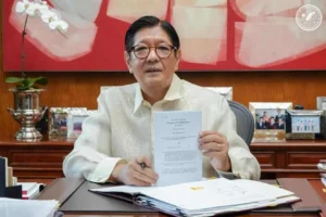 President Ferdinand R. Marcos Jr. presenting Republic Act 12317, the law that officially moves the first BARMM parliamentary elections to September 2026.