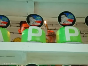 A supporter lighting one of 81 cakes during the 81st birthday celebration for former President Rodrigo Duterte at Divisoria Kiosko in Cagayan de Oro.