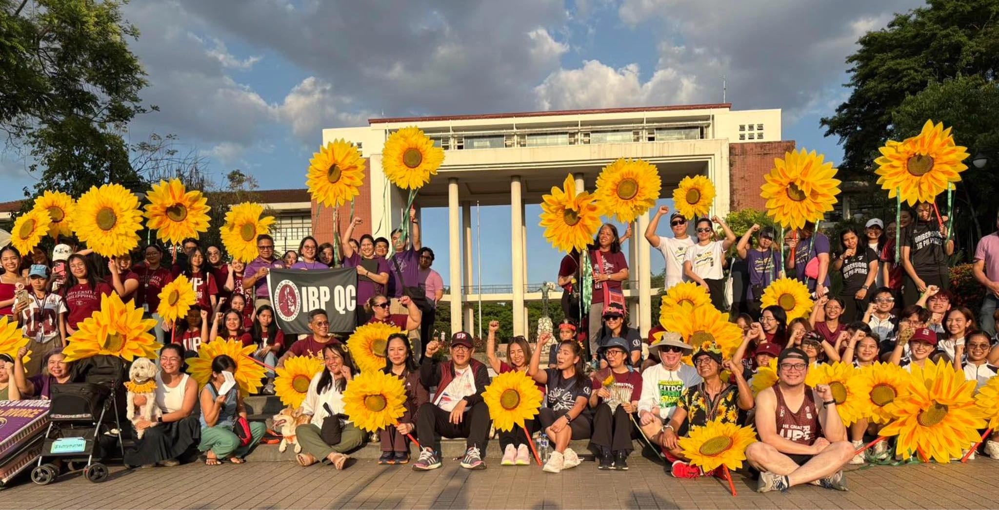 Participants carry giant sunflower lanterns around the academic oval during the 4th UP Sunflower Run-Walk-Parade to advocate for women's rights and anti-misogyny in 2026.
