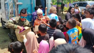 Army personnel and Inner Wheel Club members distributing food packs and essential supplies to Omayamnon families at Dimayon Elementary School.