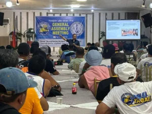 Atty. Sonny Matula and Joel Tongco lead the Macajalar Labor Union–FFW general assembly in Initao, Misamis Oriental, to support Newtech Pulp Inc. striking workers.
