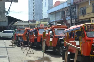 DSWD-10 officials and tricycle drivers during the ₱5,000 cash grant payout in Northern Mindanao, showing the required documents for the AICS transport subsidy.