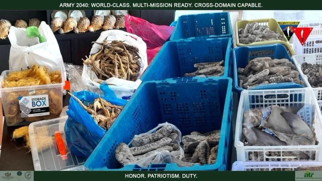 Philippine law enforcement and 1ID personnel stand with four arrested foreign nationals and seized smuggled exotic animals in Zamboanga Peninsula.
