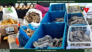 Philippine law enforcement and 1ID personnel stand with four arrested foreign nationals and seized smuggled exotic animals in Zamboanga Peninsula.