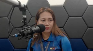 RMN-Cagayan de Oro News Director Menzie Montes prepares for a broadcast in the station's studio. Montes is currently facing a privacy complaint filed by a city official regarding a public interest report on delayed student scholarships. (Screengrabbed image from iFm Fb Page)