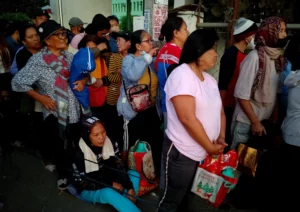 People sleeping on pavements outside the NFA gate in Cagayan de Oro to buy cheap subsidized rice.