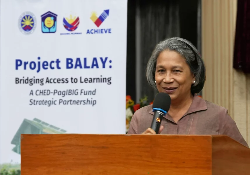Pag-IBIG Fund CEO Marilene Acosta speaking at the CHED Auditorium for the Project BALAY housing initiative.