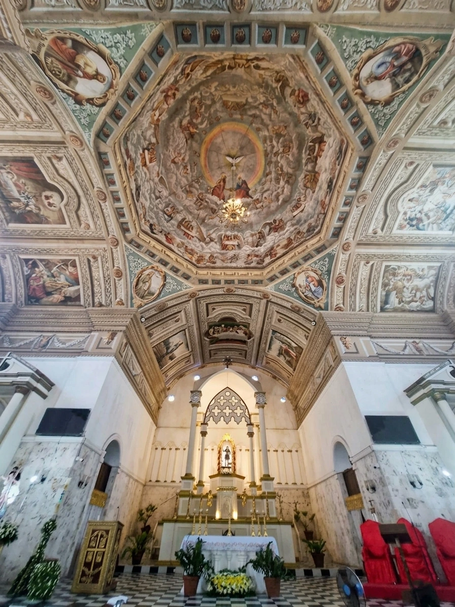Interior view of San Isidro Labrador Parish Church in Tubigon, Bohol, featuring the octagonal ceiling with the 'di sotto in su' trompe-l'œil mural of Mary's Coronation by Raymundo Francia