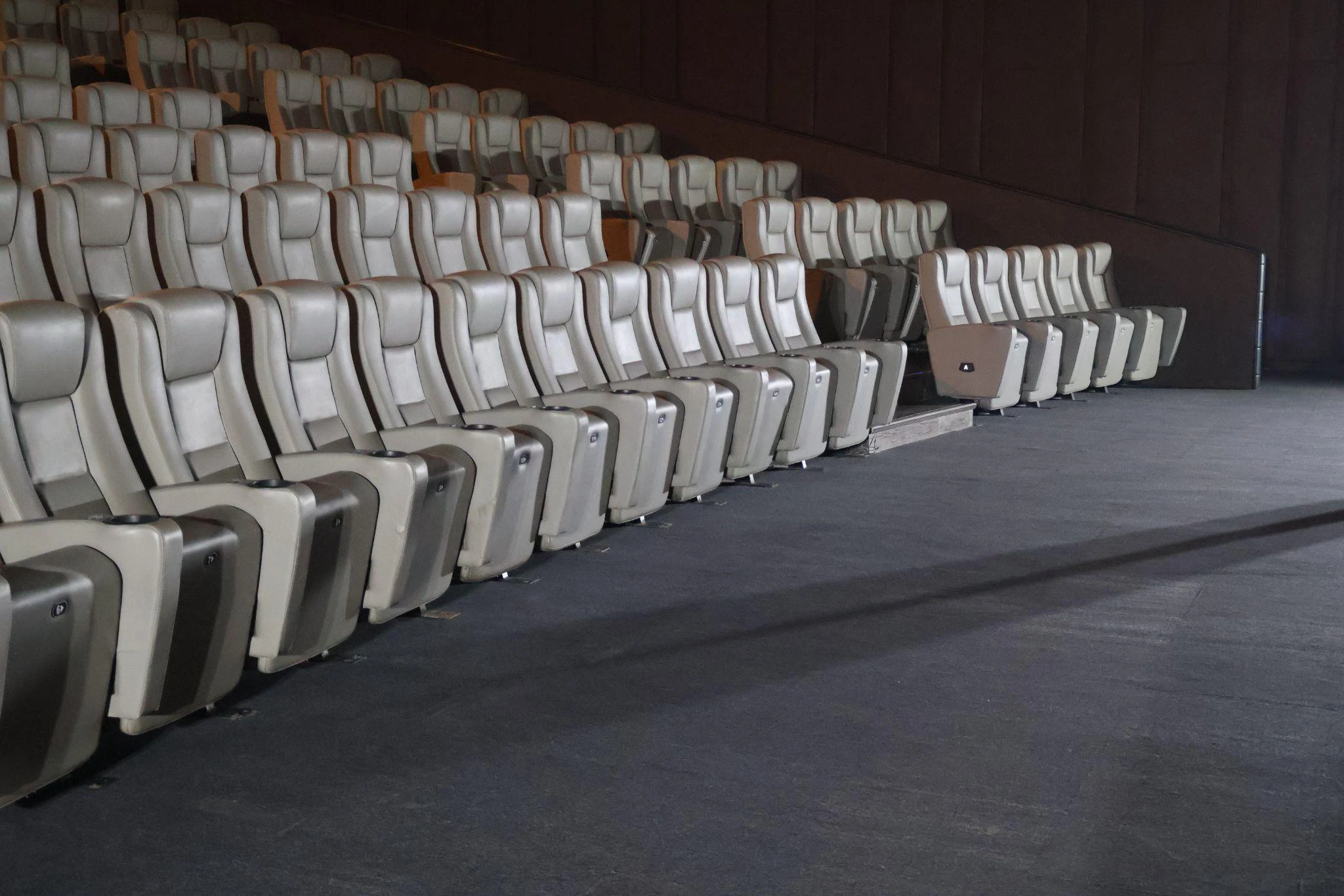 The modern interior of Cinema 2 at Ayala Malls Centrio featuring spacious ergonomic seating and acoustic fabric wall panels for an immersive viewing experience.