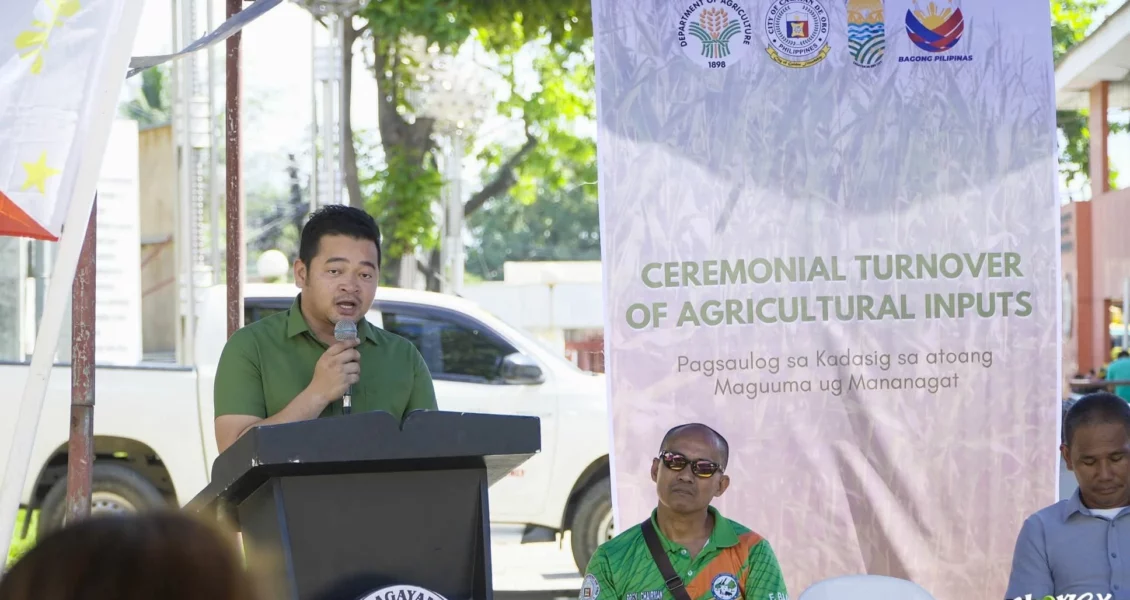 Local farmers receiving sacks of hybrid corn seeds and urea fertilizers at a municipal distribution center in Cagayan de Oro City.