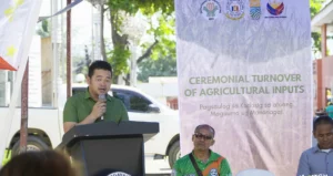Local farmers receiving sacks of hybrid corn seeds and urea fertilizers at a municipal distribution center in Cagayan de Oro City.