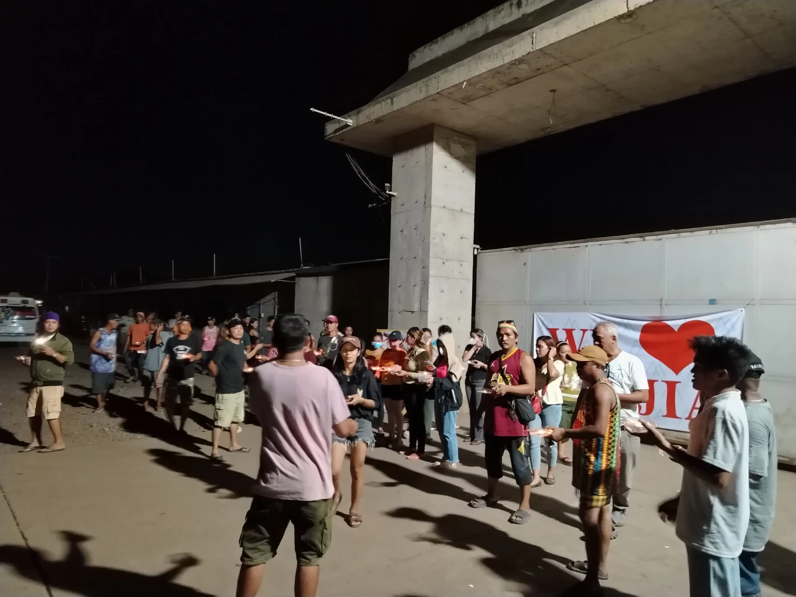 Displaced workers of Philippine Sanjia Steel Corporation holding a peaceful prayer rally outside the company's closed steel mill gates in Tagoloan.