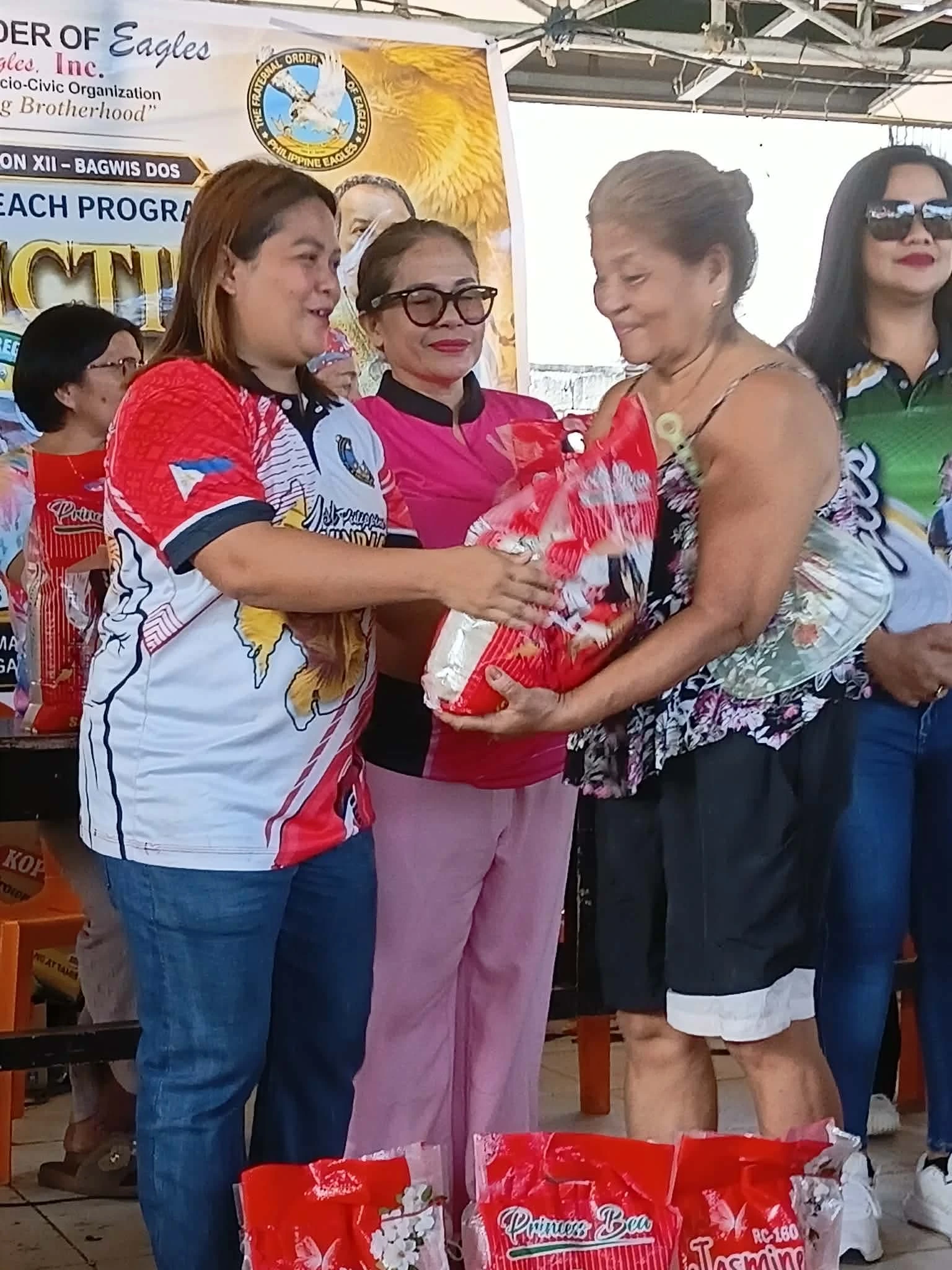 Members of the Fraternal Order of Eagles NMR 12 distributing rice, food packs, and clothing to fire-affected residents in Barangay Camaman-an, Cagayan de Oro City.