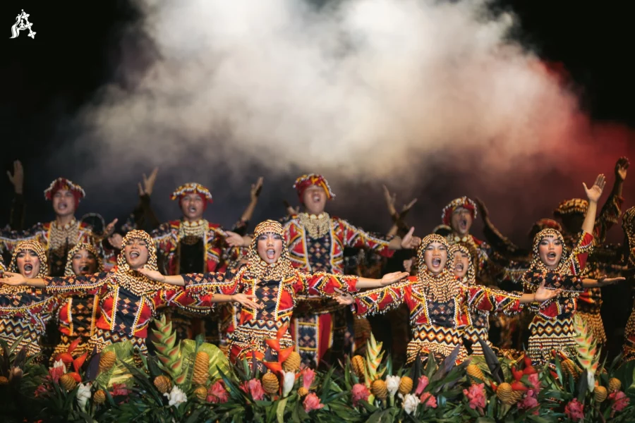 Dancers in traditional Agsurnon attire executing a synchronized cultural performance on the open stadium field during the national games.