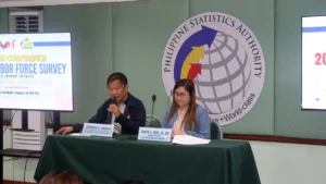 DOLE-10 Technical Support Services Division Chief Atheneus A. Vasallo speaking into a microphone alongside PSA-10 Regional Director Dr. Janith C. Aves at a labor force survey press conference table.