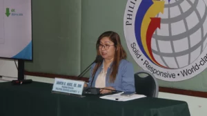 PSA Region 10 Regional Director Dr. Janith C. Aves speaking at a press conference next to digital displays showing the 2024 and 2025 Labor Force Survey unemployment data.