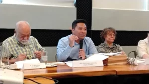 Lawyer Ralph Metrillo reviewing a copy of the official DENR Notice of Hearing regarding the Xavier University Manresa land dispute.