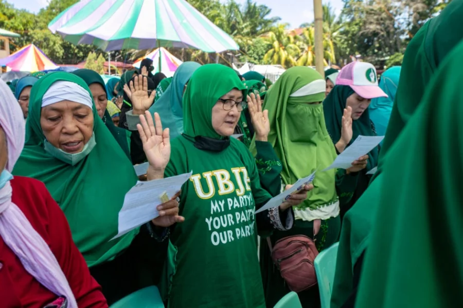 Women supporters of the United Bangsamoro Justice Party (UBJP) raising their hands to take an oath during a general assembly ahead of the September 14 Bangsamoro parliamentary elections.