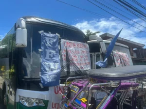 Federation of Free Workers President Sonny Matula eating a meal with striking transport drivers on a picket line in Infanta, Quezon.