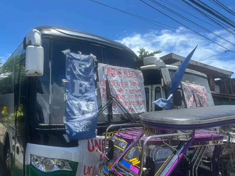 Federation of Free Workers President Sonny Matula eating a meal with striking transport drivers on a picket line in Infanta, Quezon.