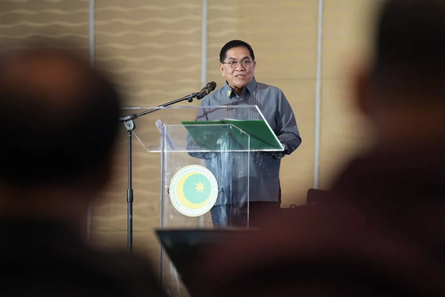Bangsamoro Chief Minister Abdulraof Macacua speaking into a microphone during a press conference at the Bangsamoro Government Center.