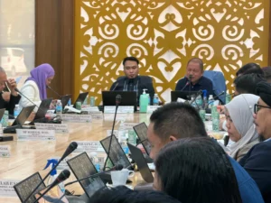 Members of the Bangsamoro Transition Authority Parliament sit at long conference tables inside the Pangalian M. Balindong Hall in Cotabato City during an oversight hearing with education officials.