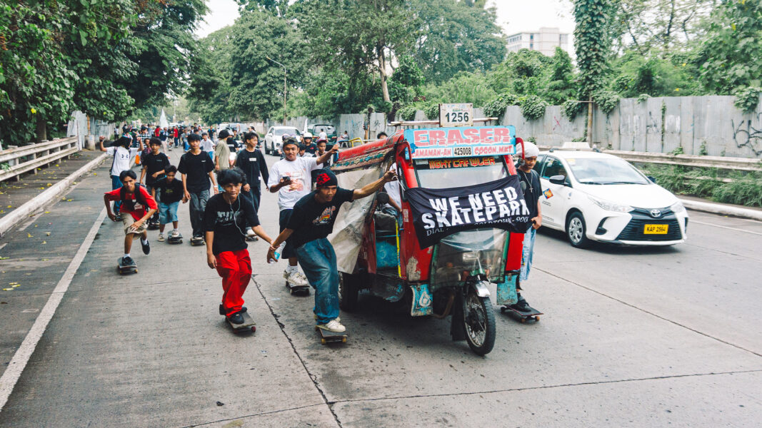 A group of young local skateboarders holding their boards stand on a concrete path during a public demonstration along Rio Boulevard in Cagayan de Oro City.