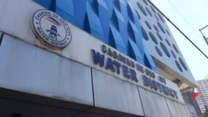 An exterior view of a localized water treatment plant facility featuring industrial blue pipelines, pressure gauges, and storage tanks under a bright sky in Cagayan de Oro City.