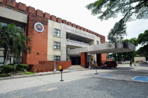 The exterior facade and official signage of the Commission on Higher Education central office building in Quezon City.