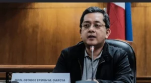 Commission on Elections Chairman George Garcia speaks at a podium during the Bangsamoro Parliamentary Election Forum in Zamboanga City.