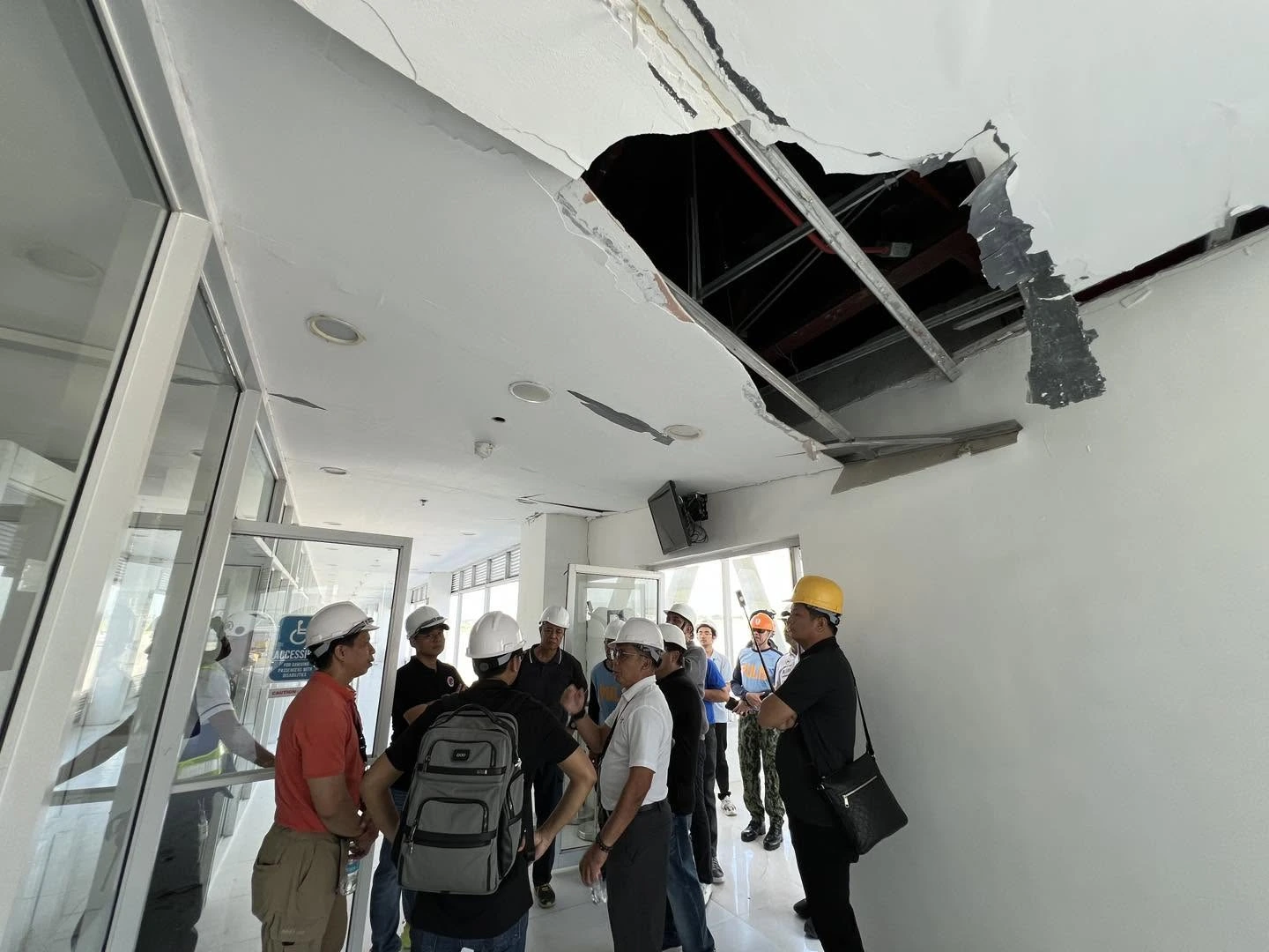 DOTr Secretary Banoy Lopez surveys earthquake damage at the General Santos International Airport terminal building.