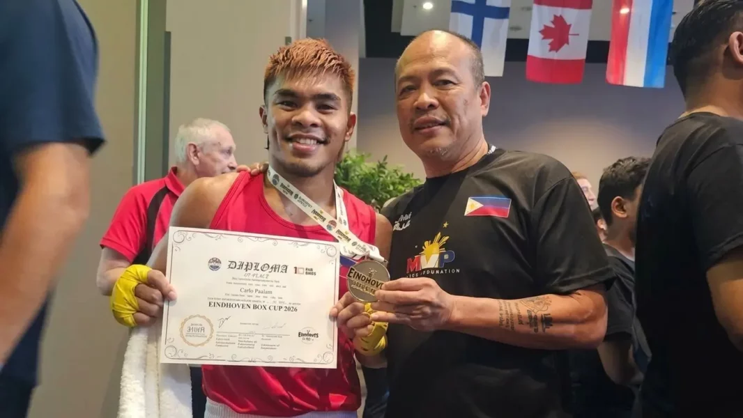 National boxing coach Elmer Pamisa standing proudly alongside boxer Carlo Paalam as they hold the gold medal trophy at the Eindhoven Box Cup in the Netherlands.
